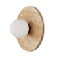 Decorative wall sconce with beige circular plate and white spherical bulb on a white background