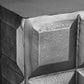 Close-up of a corner where concrete blocks meet, showing texture and joint.
