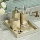 Bathroom accessories set on a tray with a sink and tiles in the background
