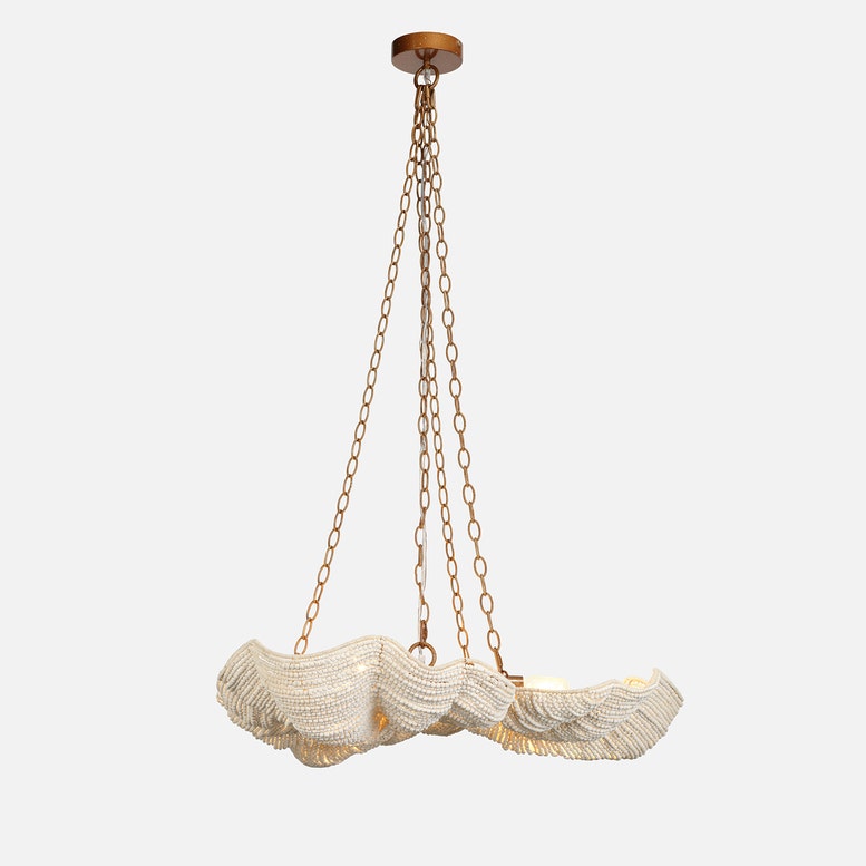 Decorative pendant light with ruffled design and gold chain on a white background