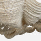 Close-up of a beige beaded clutch bag with a textured surface.