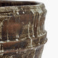 Close-up of a textured brown ceramic pot on a white background