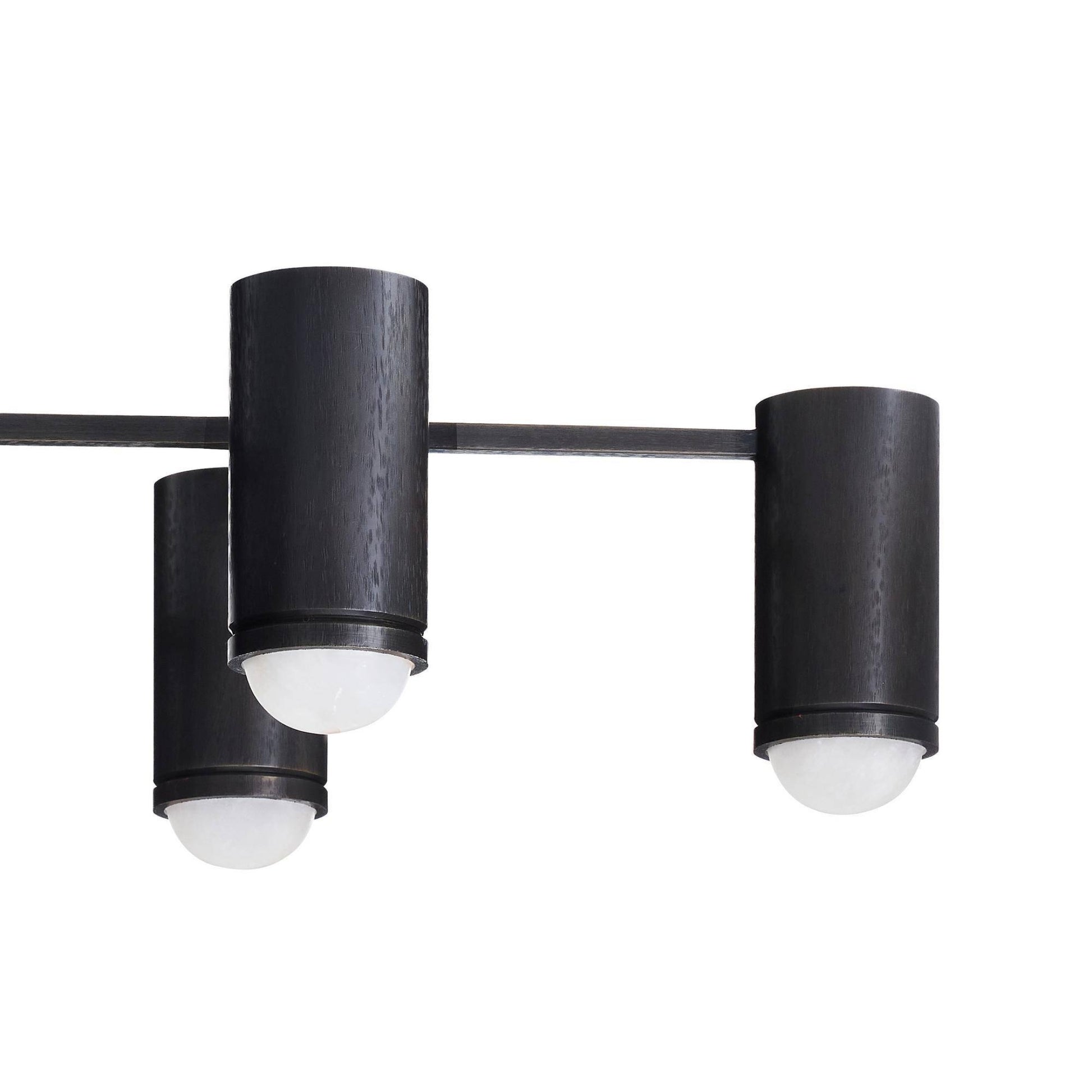 Modern black ceiling light fixture with three cylindrical shades on a white background
