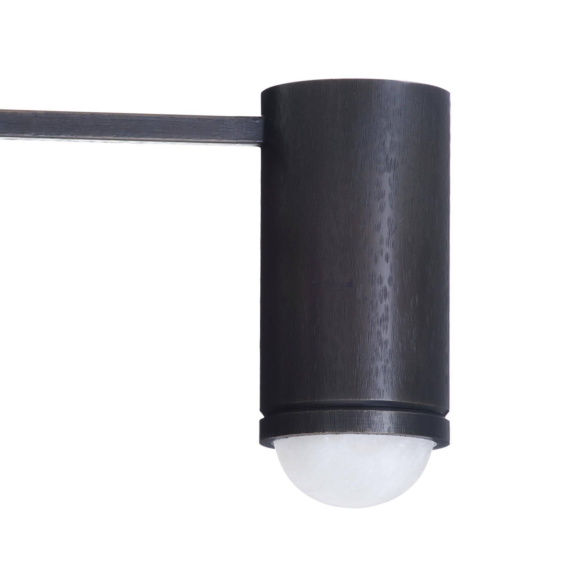 Black cylindrical outdoor light fixture on a white background