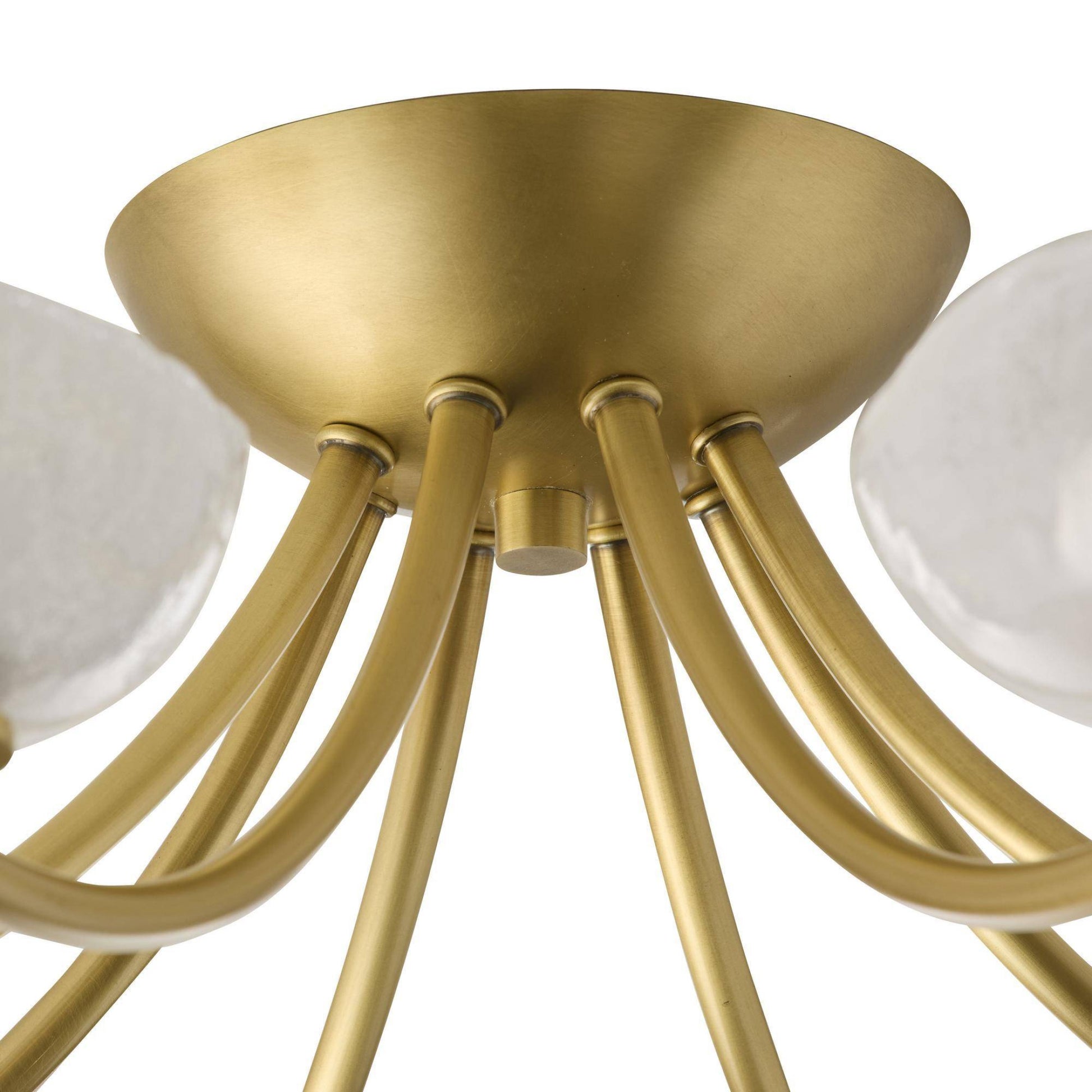 Gold chandelier with white glass shades on a white background