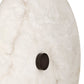 Round metallic object on a textured white surface