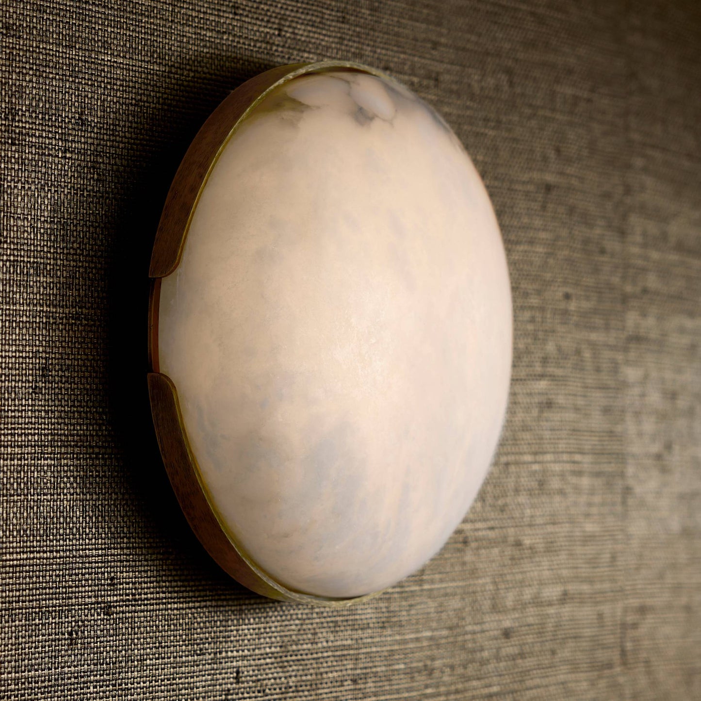 White egg with brown shell on a textured brown surface