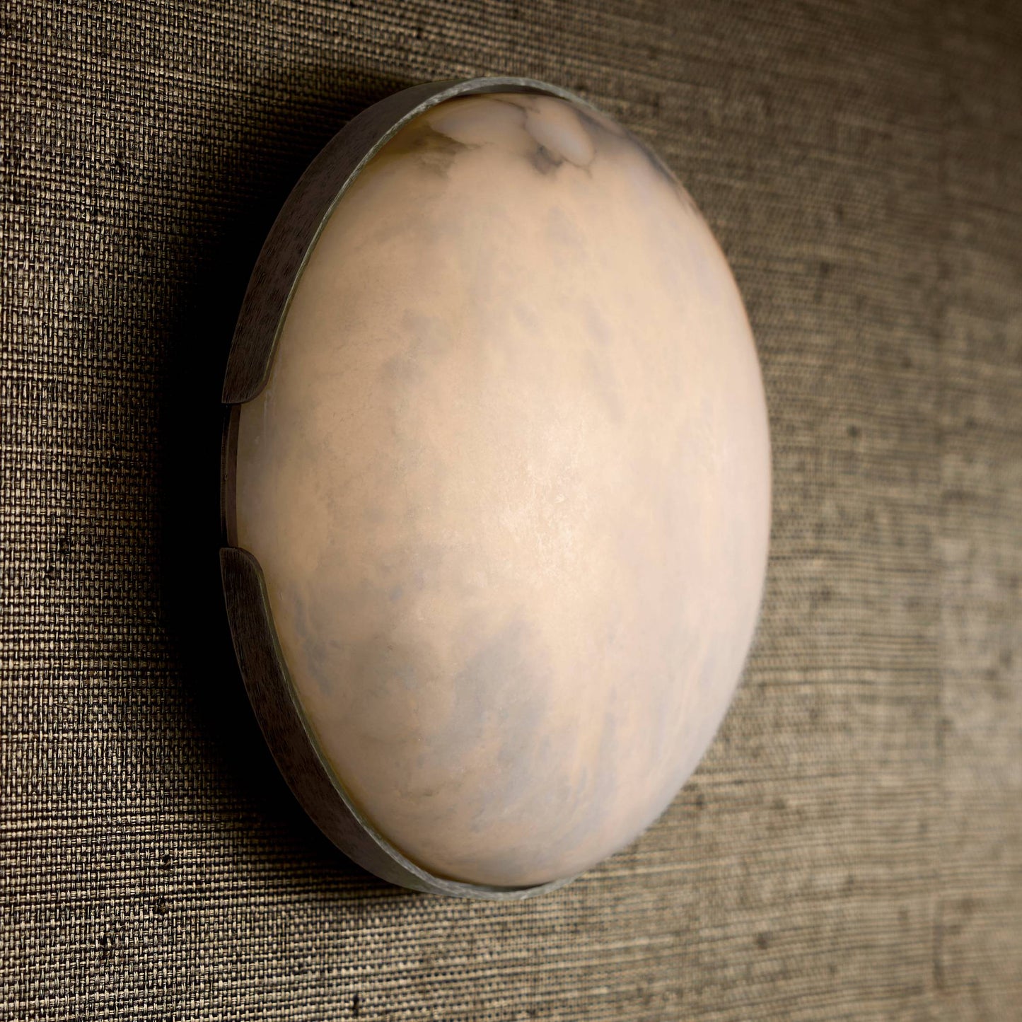 Round beige object on a textured brown surface