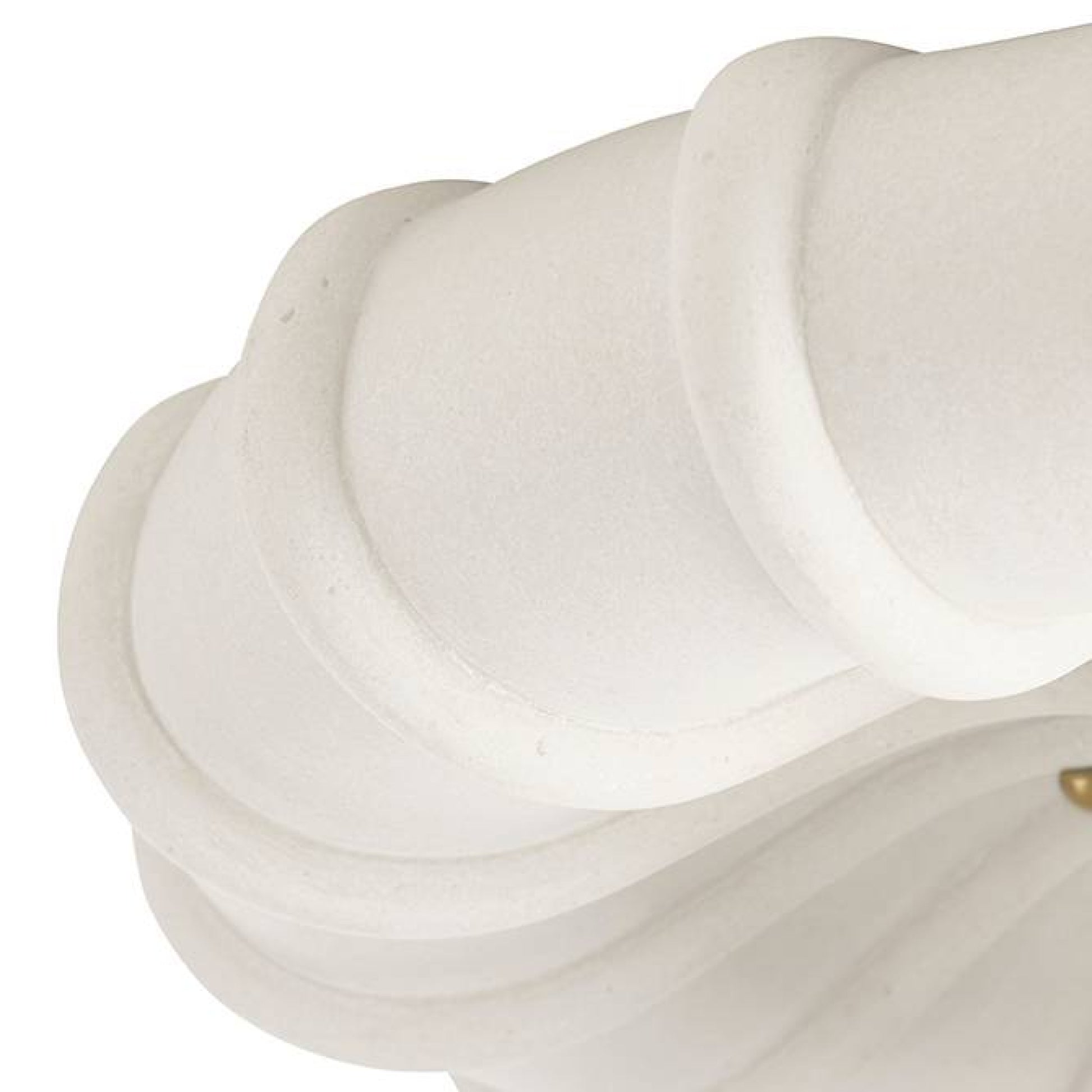 Close-up of a white marble sculpture with a gold accent on a white background