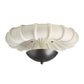 Ceiling light fixture with white floral design on a white background