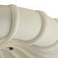 Close-up of a white ceramic vase with wavy design on a white background