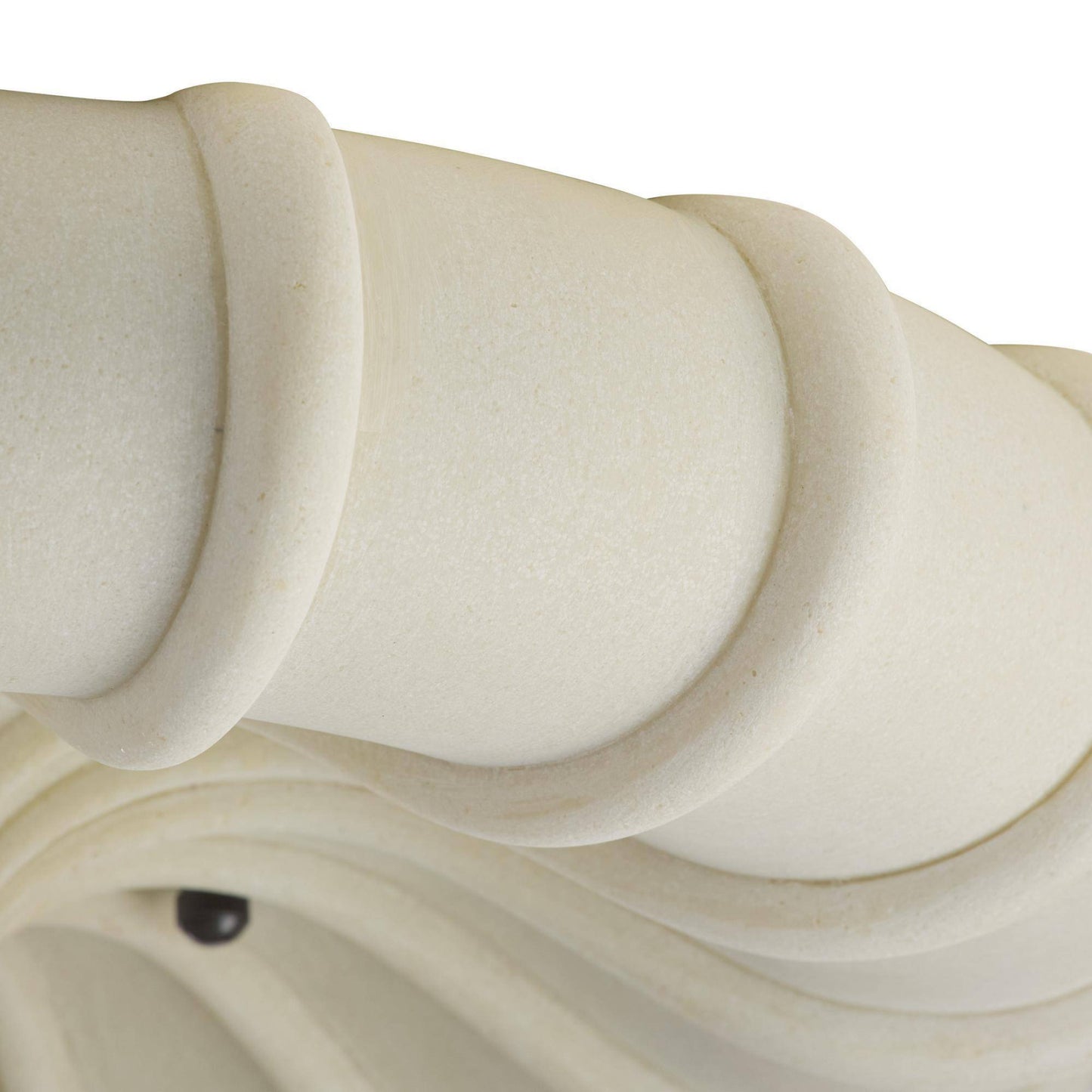 Close-up of a white ceramic vase with wavy design on a white background