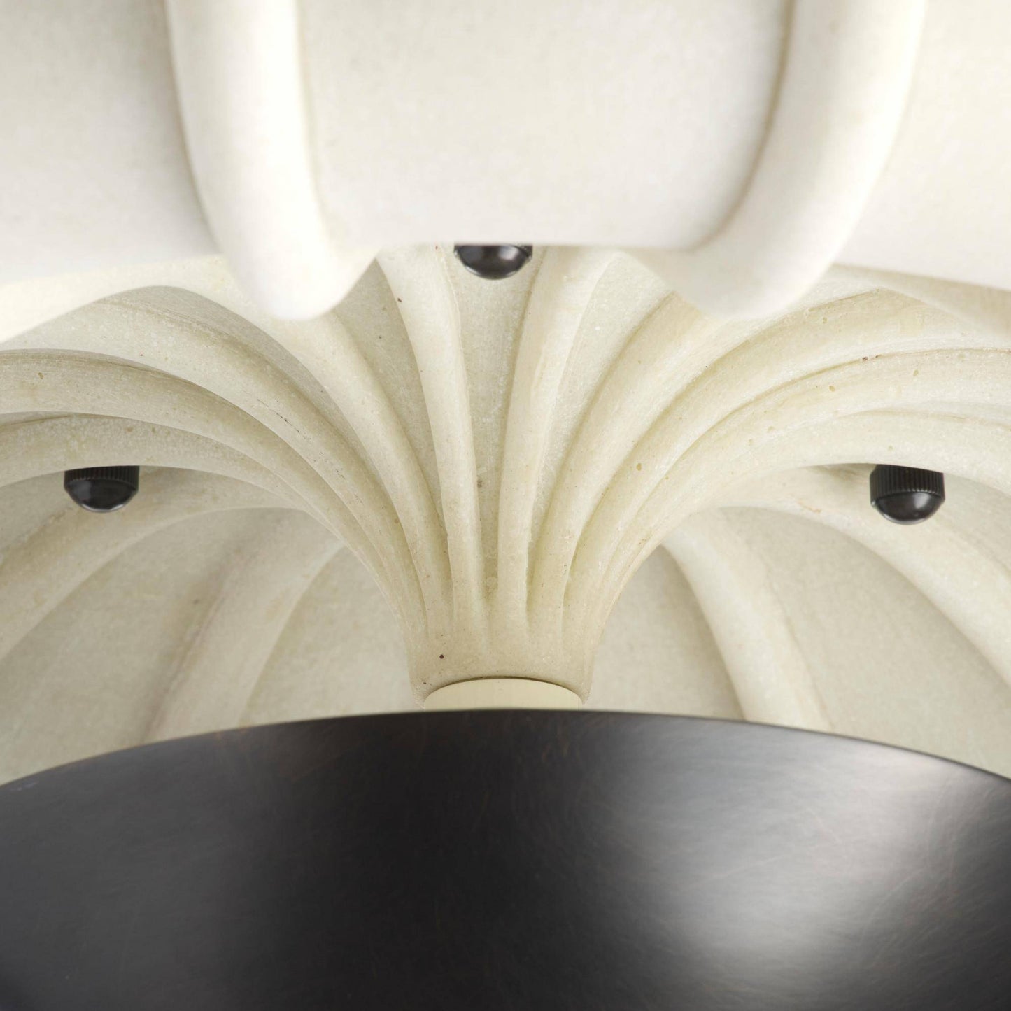 Close-up of a decorative ceiling with intricate patterns and a black light fixture.