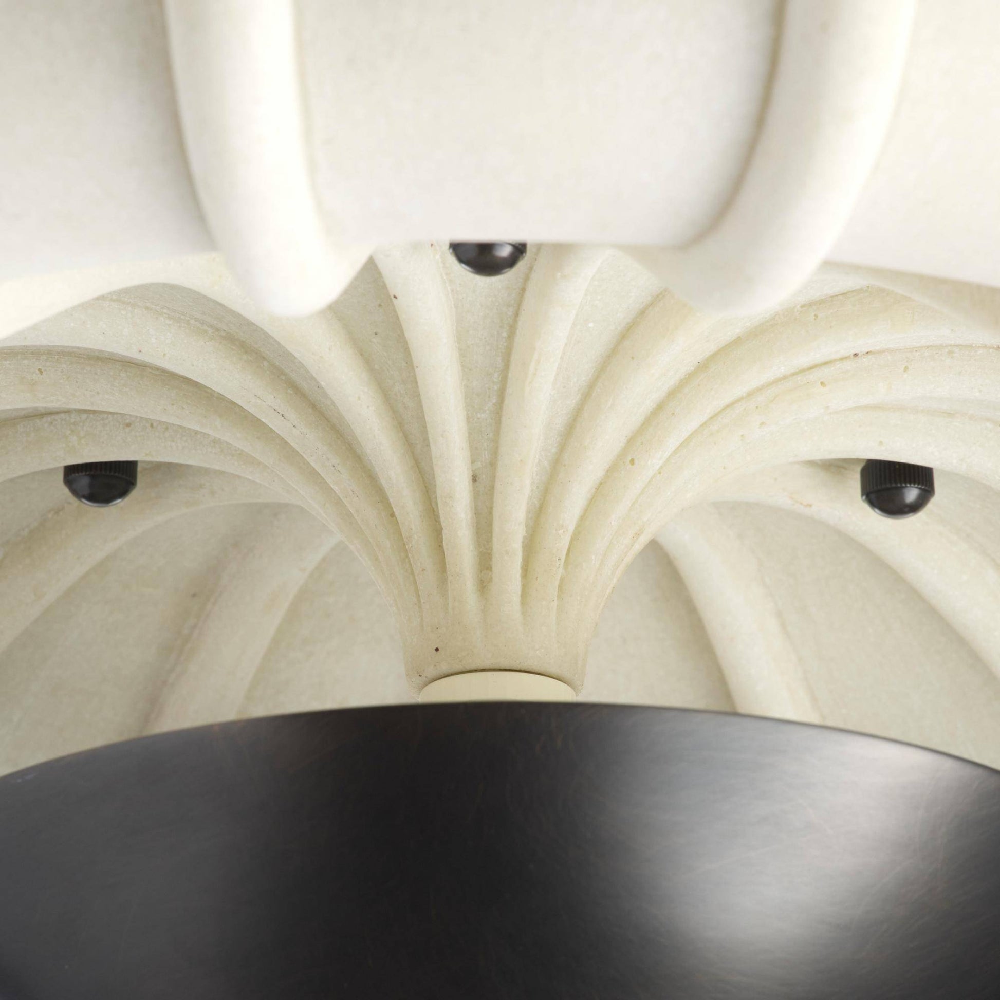 Close-up of a decorative ceiling with intricate patterns and a black light fixture.