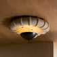 Ceiling light fixture with decorative design on a wooden ceiling