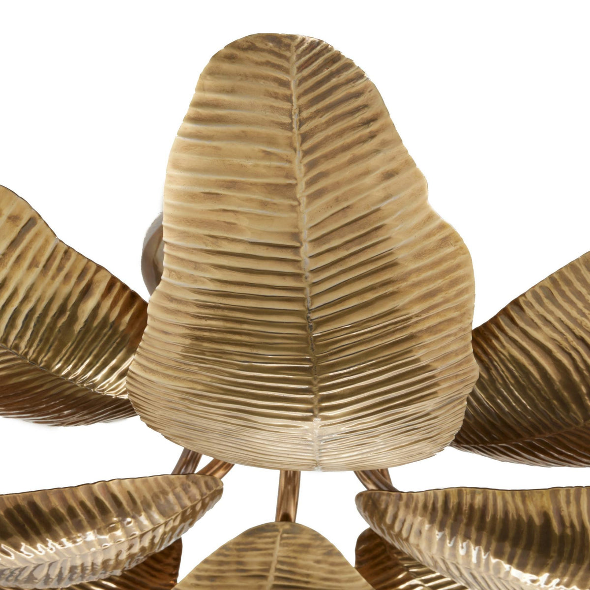 Close-up of a metallic leaf-shaped light fixture with a warm gold/brass finish and ribbed leaf textures on a white background.