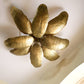 Gold leaf ceiling light fixture on a white ceiling
