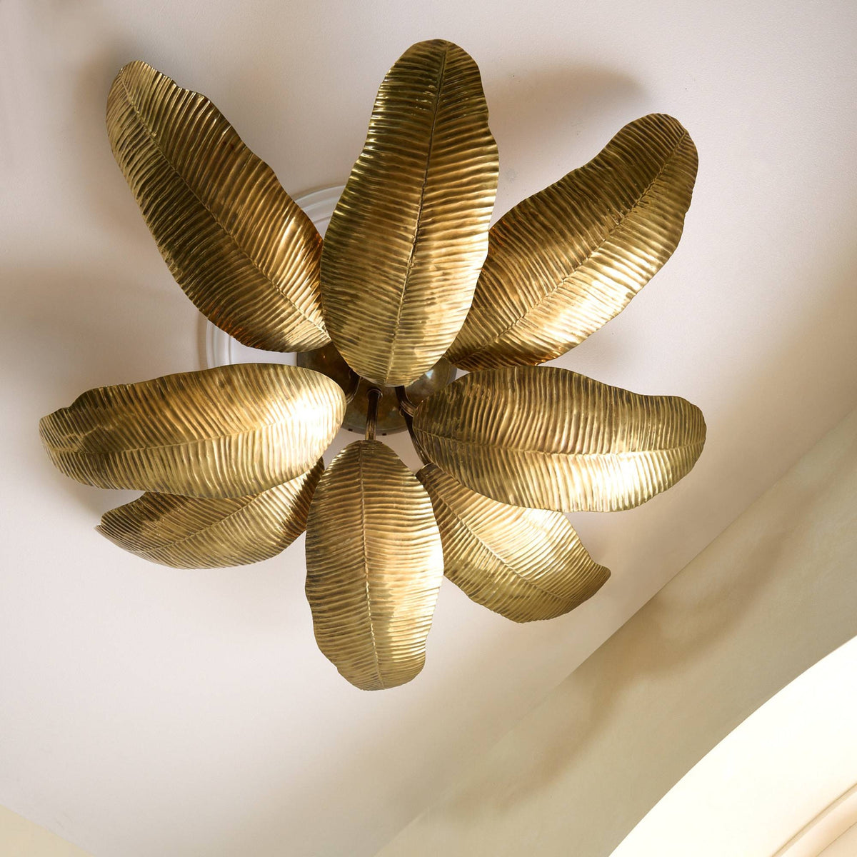 Gold leaf ceiling light fixture on a white ceiling