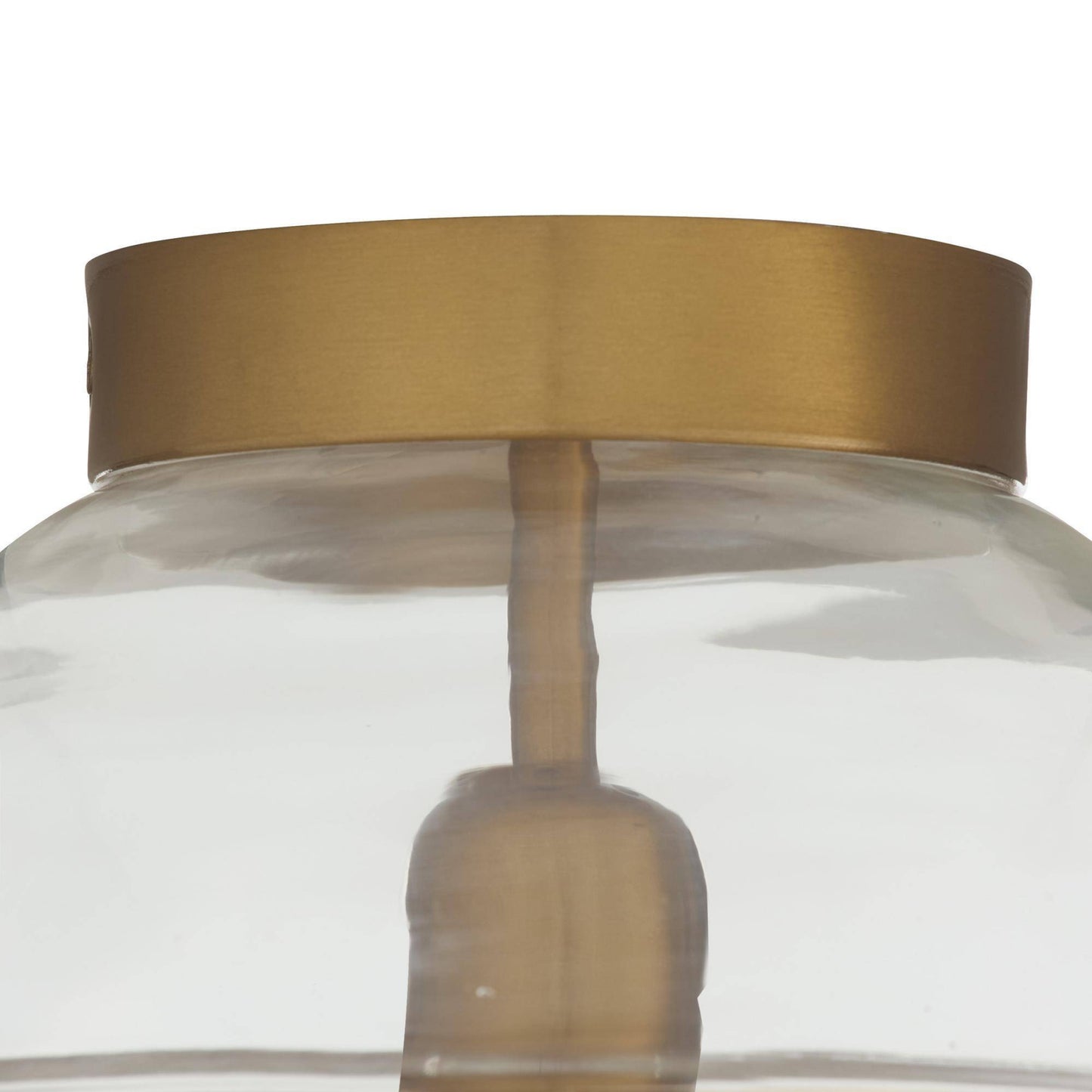 Close-up of a glass jar with a gold lid on a white background