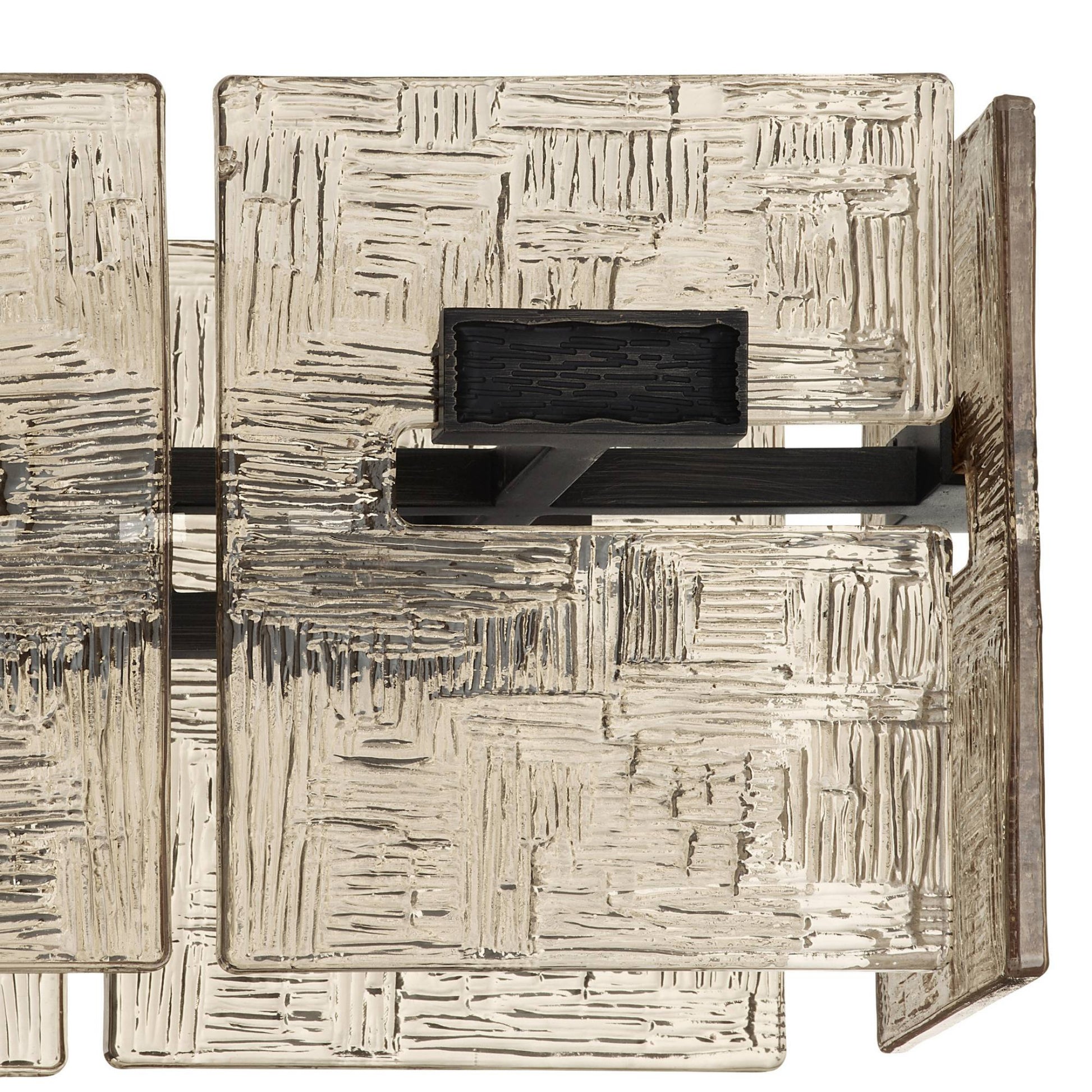 Abstract textured sculpture with geometric patterns on a white background