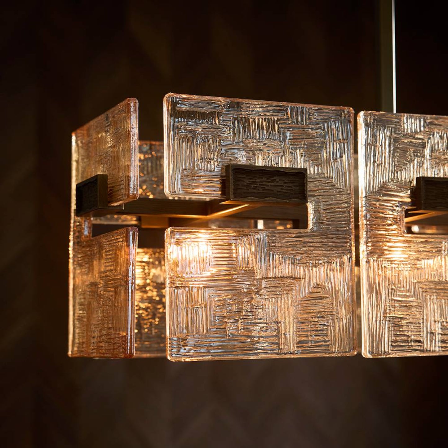 Decorative wall sconce with textured design on a dark background