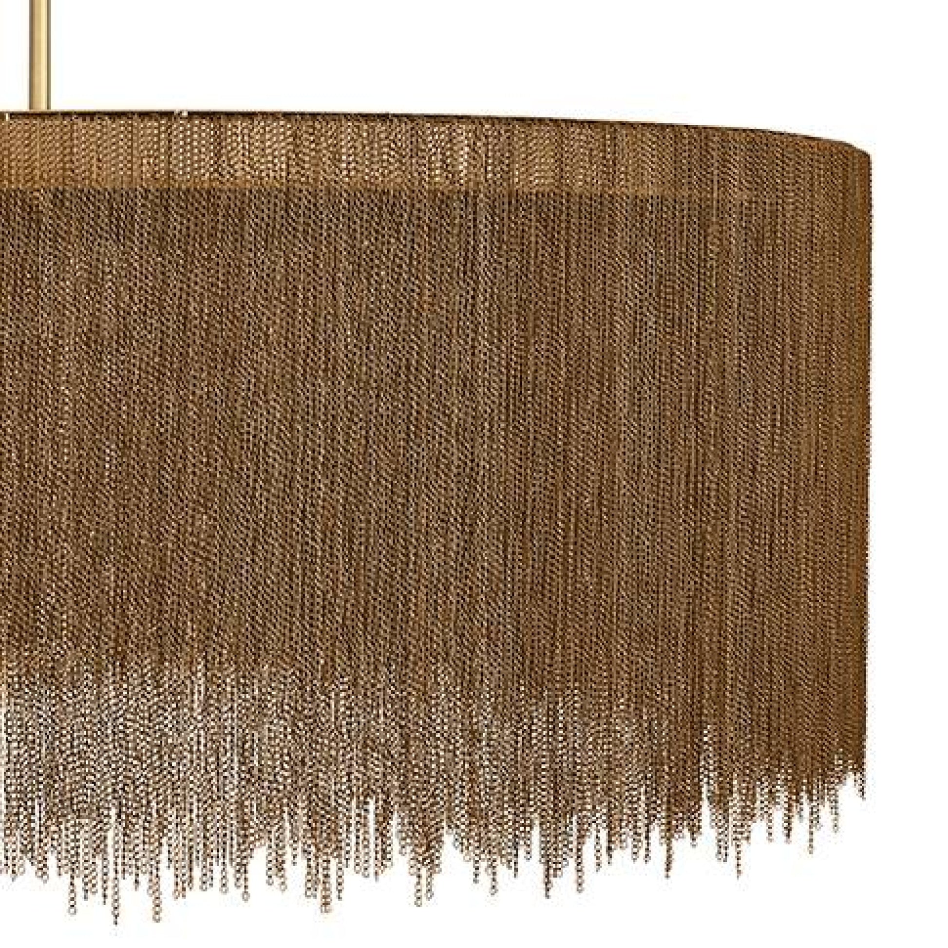 Brown textured lampshade with fringe details on a white background