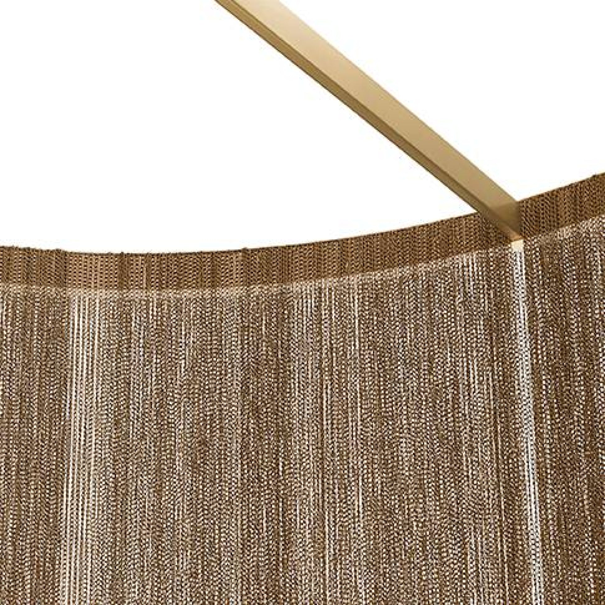 Textured brown curtain with a gold rod on a white background