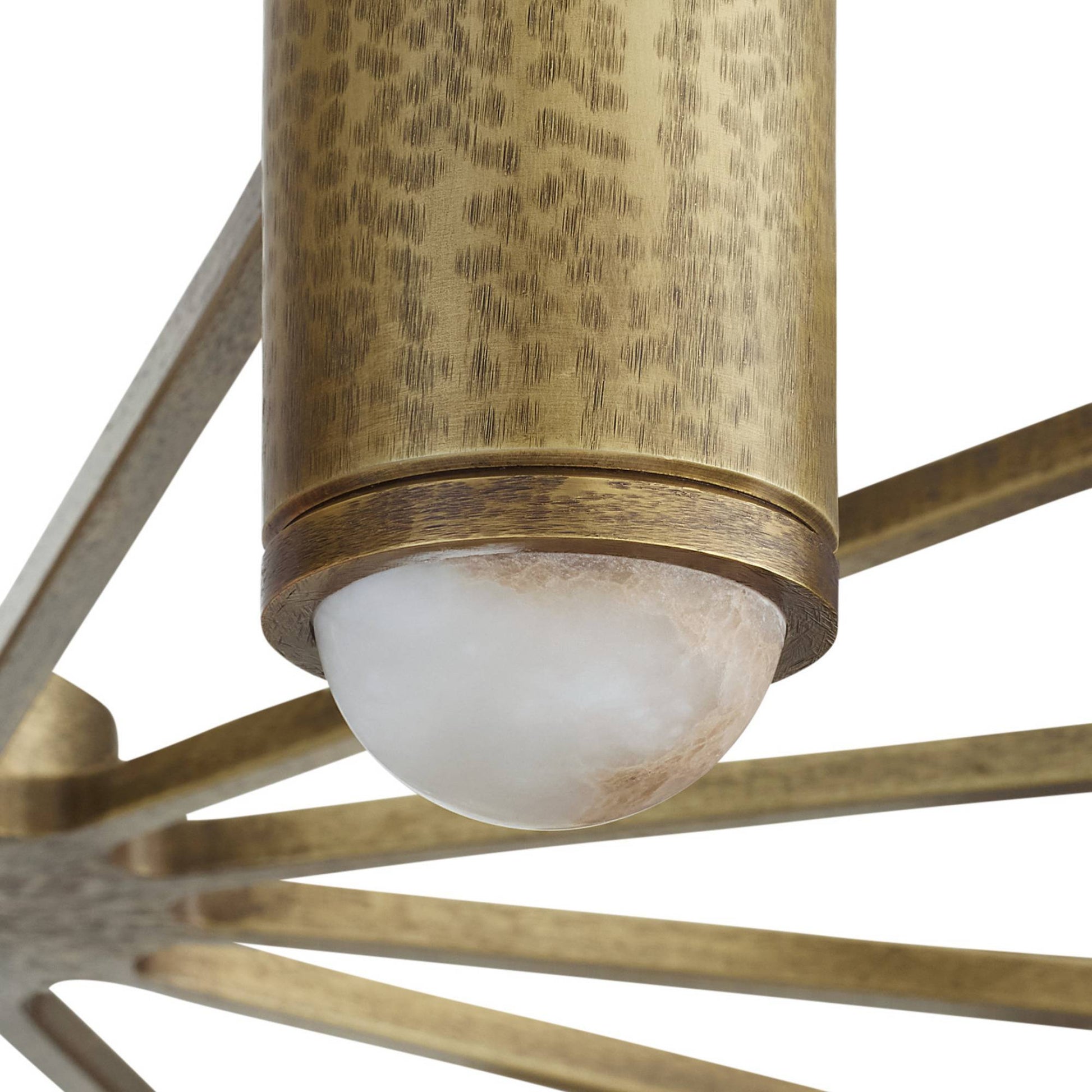 Close-up of a brass ceiling light fixture with a white bulb on a white background