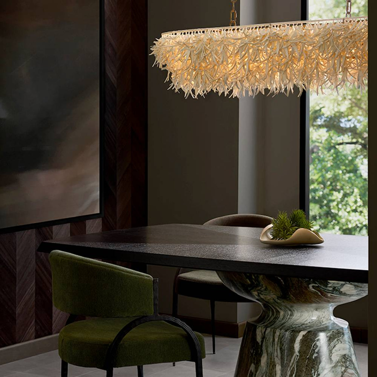 Dining room with a stylish table, chairs, and a decorative chandelier.