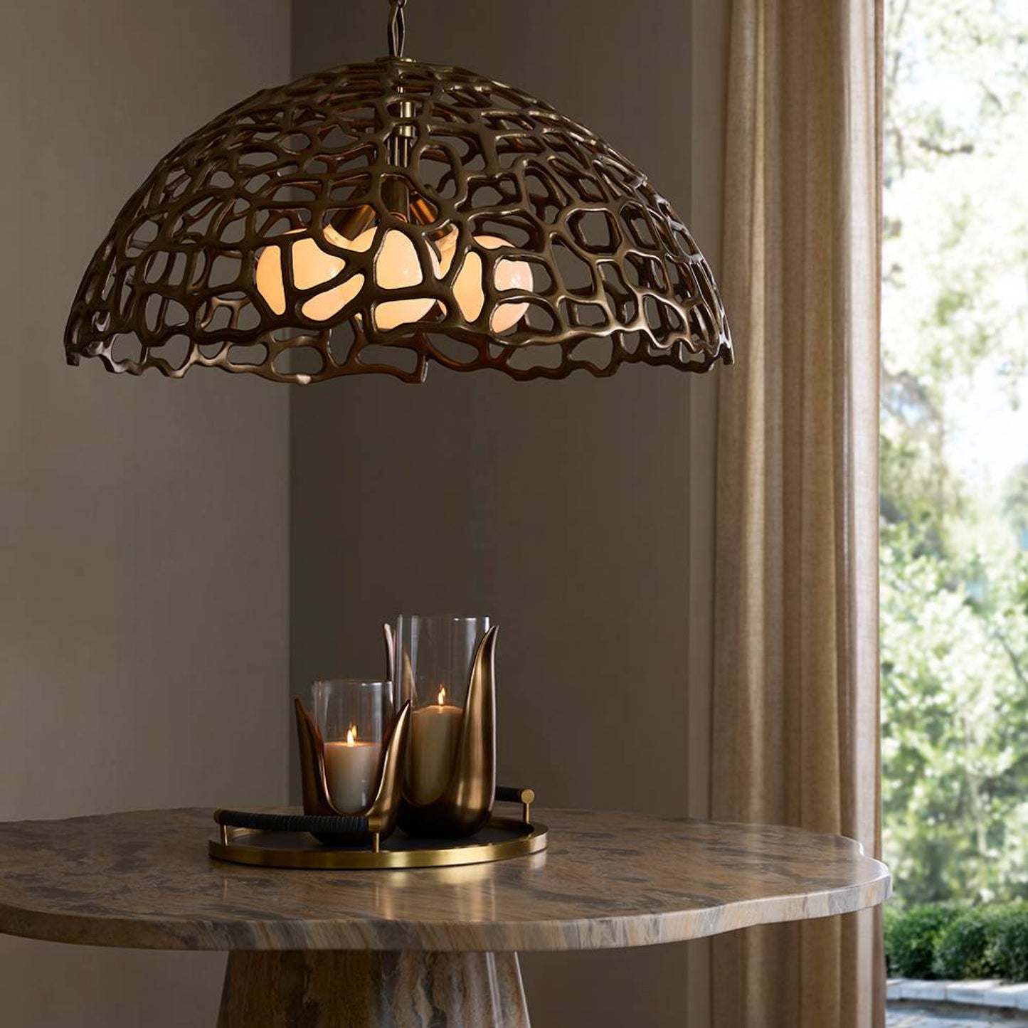Decorative pendant light with intricate design on a table against a neutral wall.