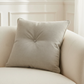 dove pillow on a beige sofa with a neutral background