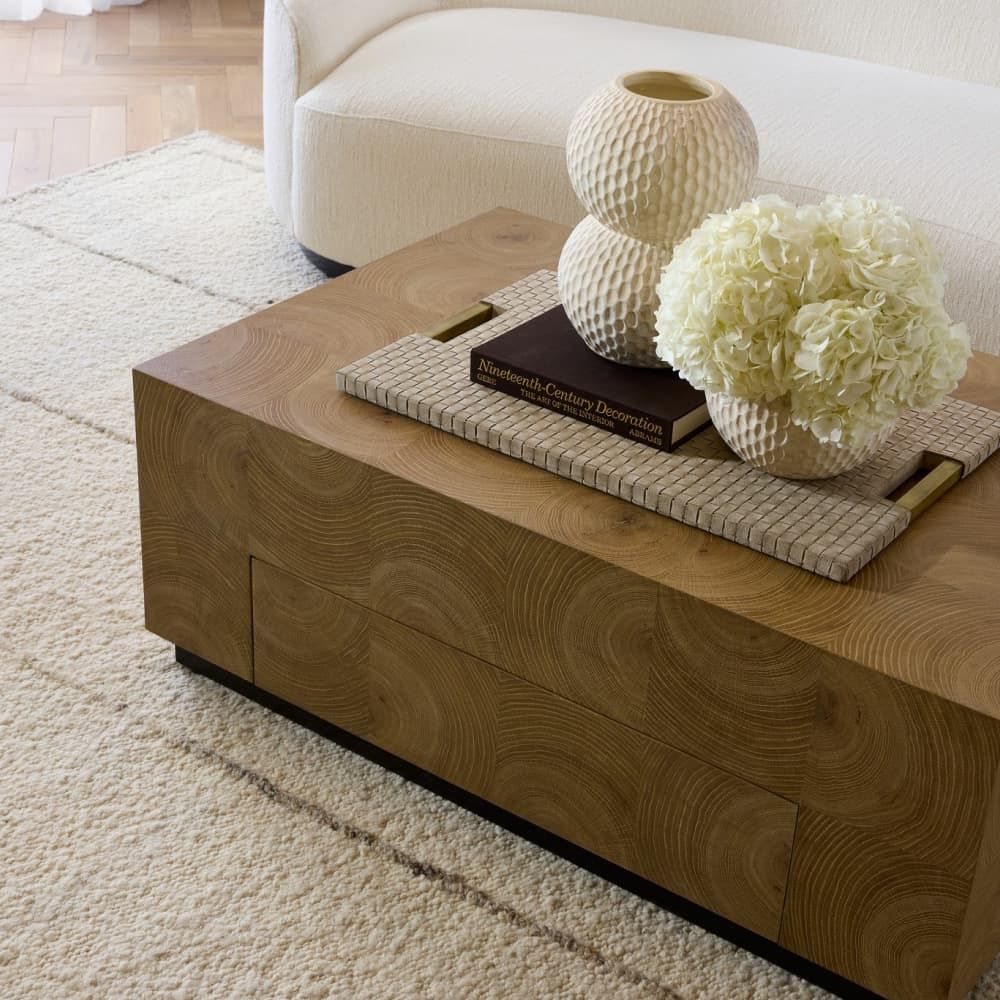 Wooden coffee table with decorative items in a living room setting
