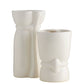 Two white ceramic tiki mugs on a white background