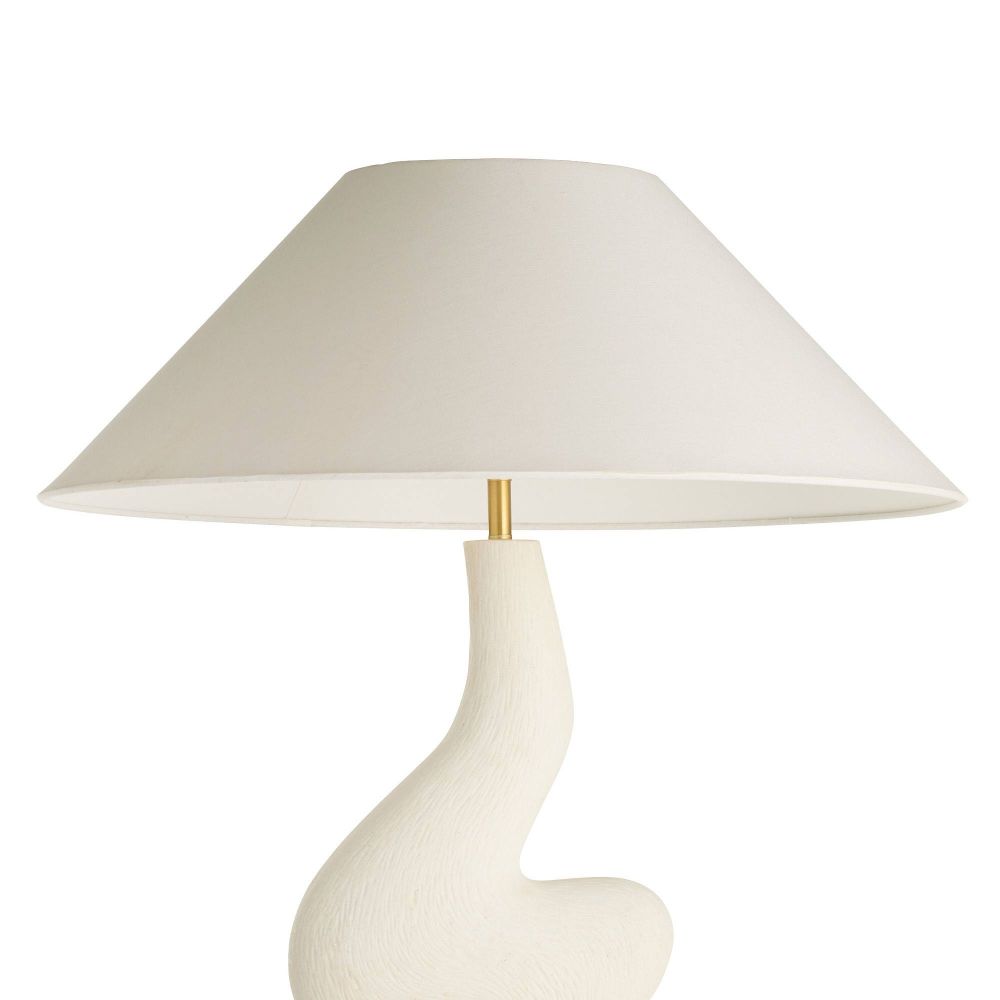 Table lamp with a white base and beige shade on a white background