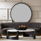 Modern living room with a round mirror, gray sofa, and marble coffee table.