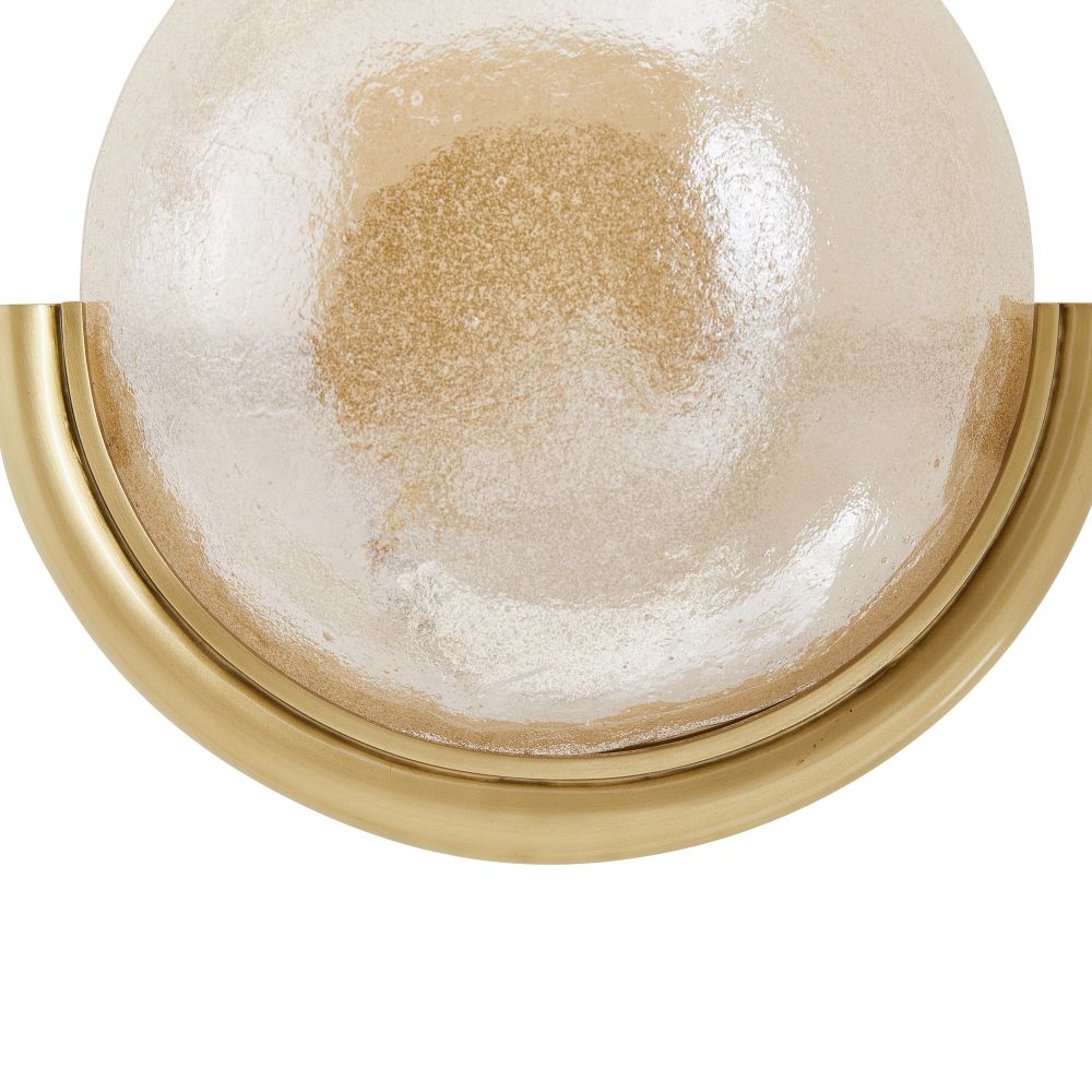 Close-up of a gold-framed round object with a textured beige center on a white background