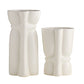 Two white ceramic vases with textured surfaces on a white background