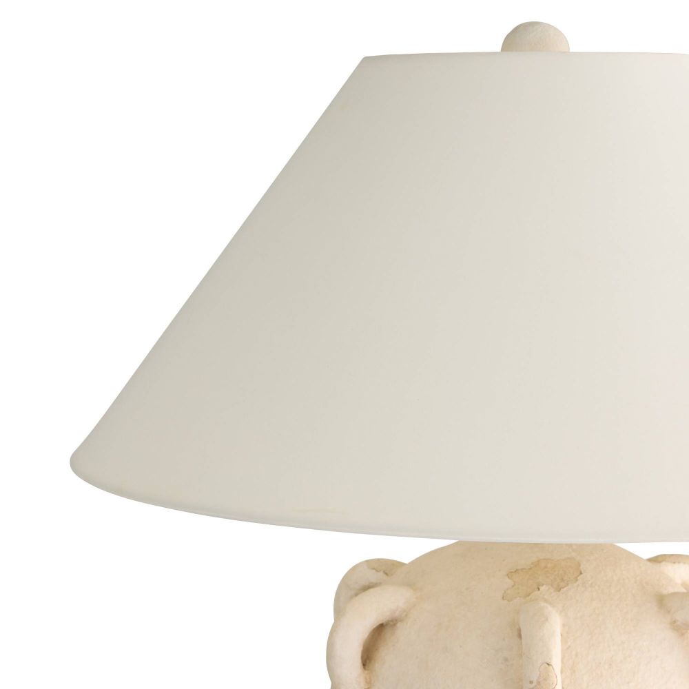 Beige ceramic lamp with a white lampshade on a white background