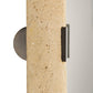 Close-up of a textured wall sconce with a neutral background
