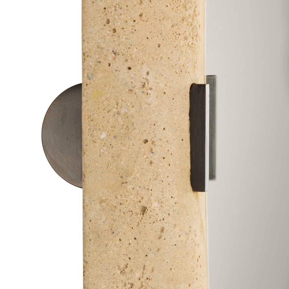 Close-up of a textured wall sconce with a neutral background