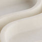 Close-up of a smooth, beige ceramic vase with a rounded design.