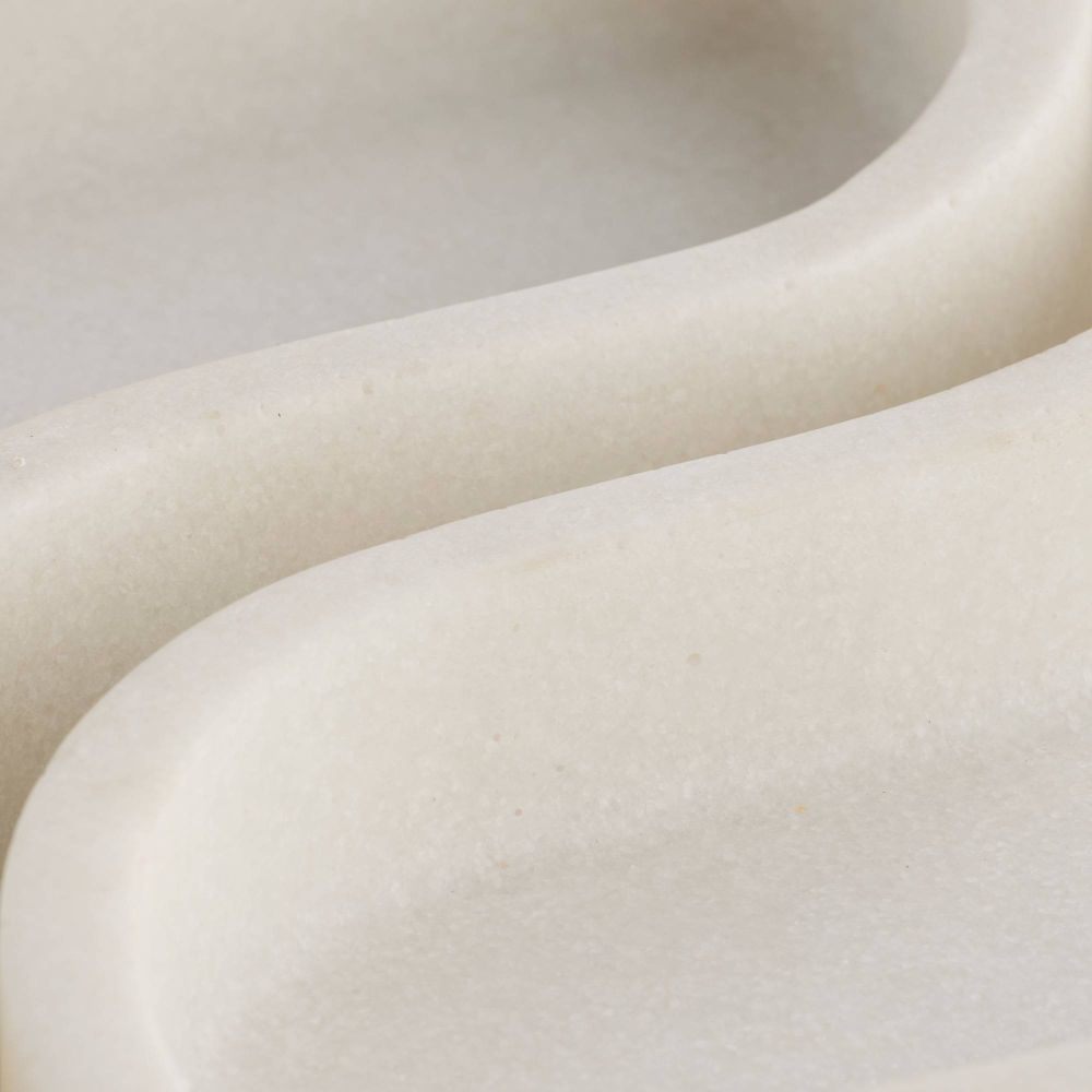 Close-up of a smooth, beige ceramic vase with a rounded design.