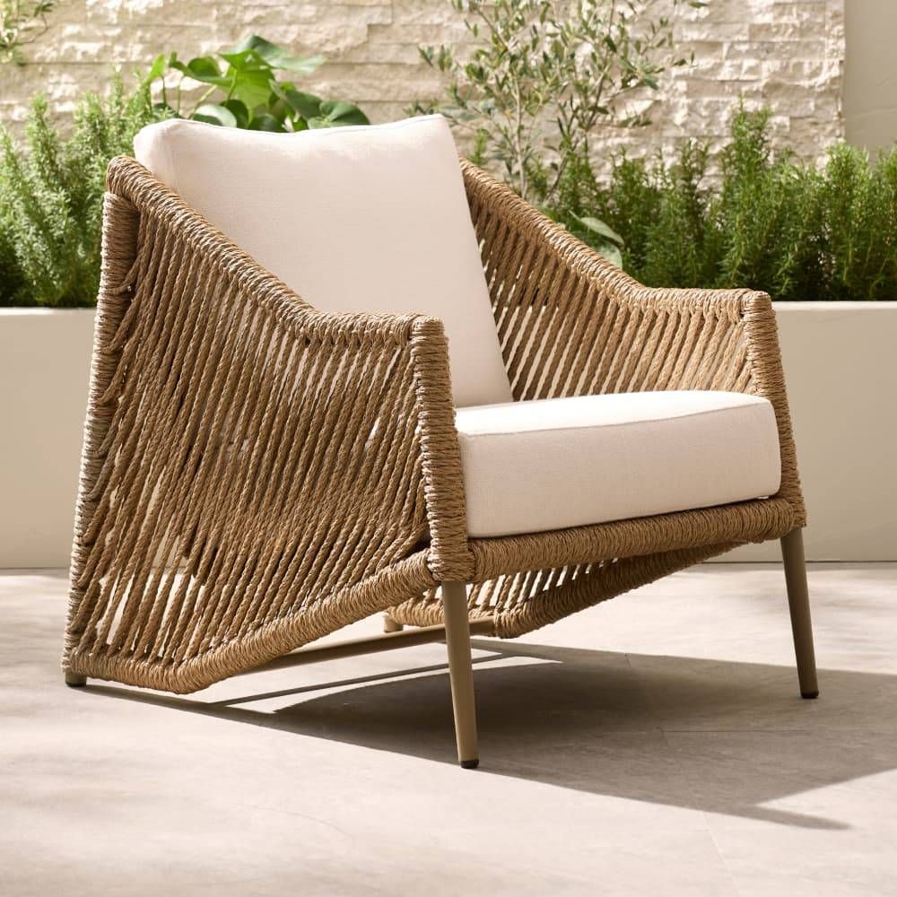 Wicker chair with white cushions on a patio
