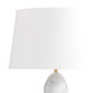 Table lamp with a marble base and white shade on a white background