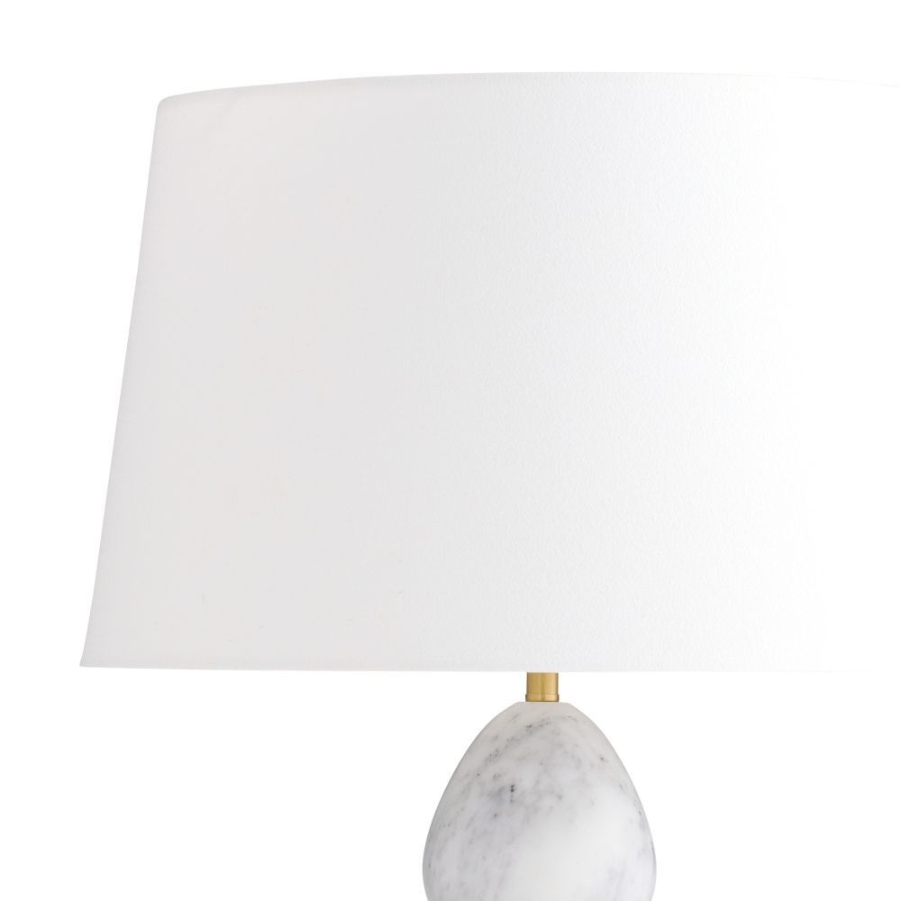 Table lamp with a marble base and white shade on a white background