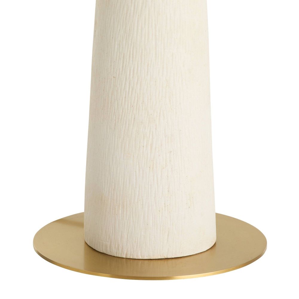 White cylindrical object with a gold base on a white background
