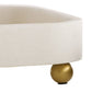 Close-up of a table with a beige cushion and gold leg on a white background