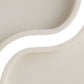 Close-up of a curved, beige ceramic vase on a white background