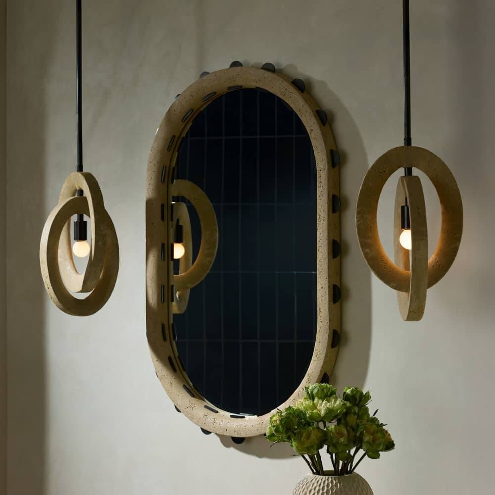 Decorative wall mirror with circular lights on a neutral background