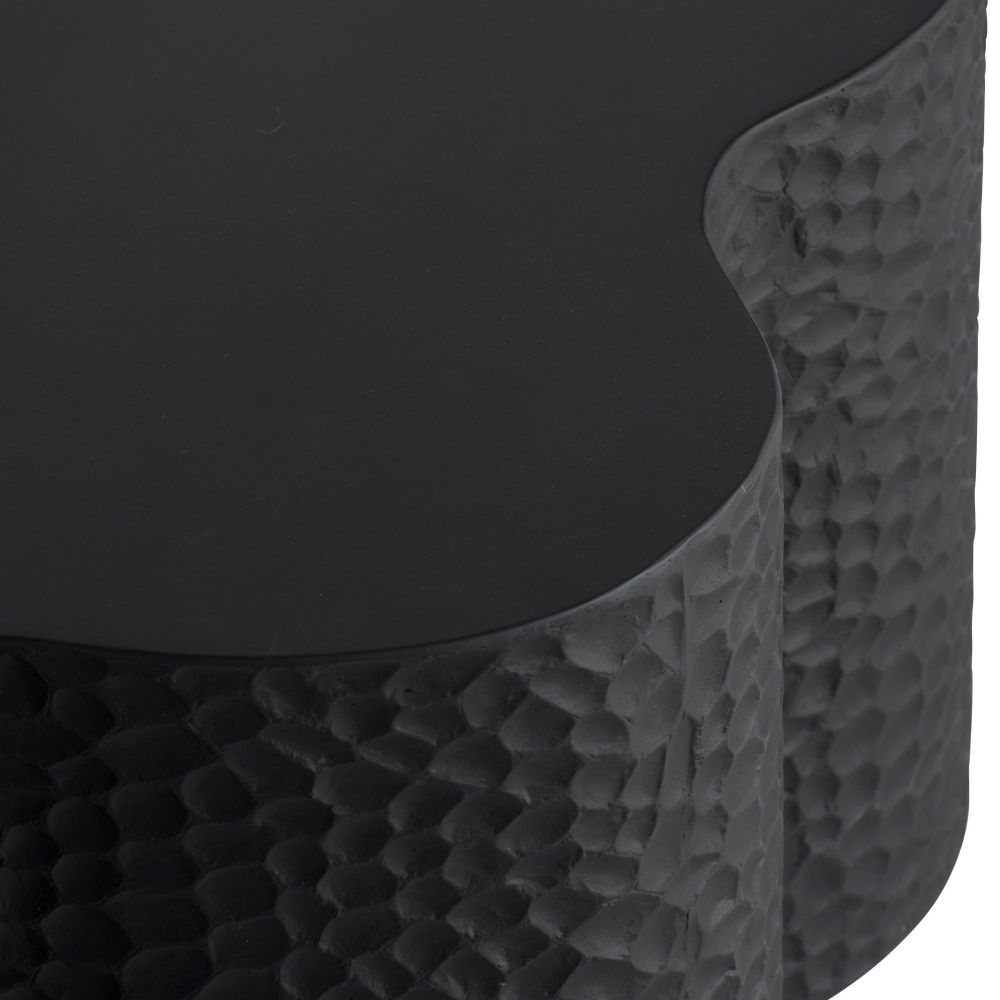 Close-up of a textured black stool with a round seat.